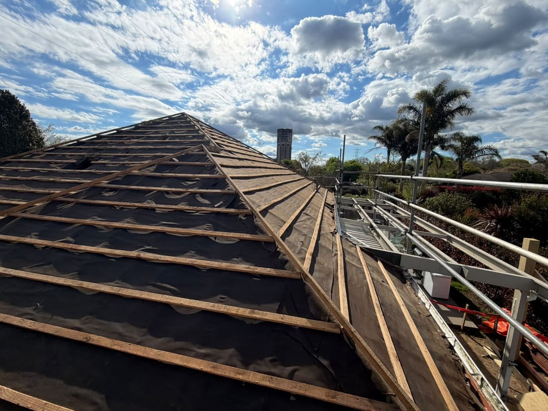The same roof stripped back to battens and building paper after asbestos Decramastic tile removal in Karapiro, Waikato