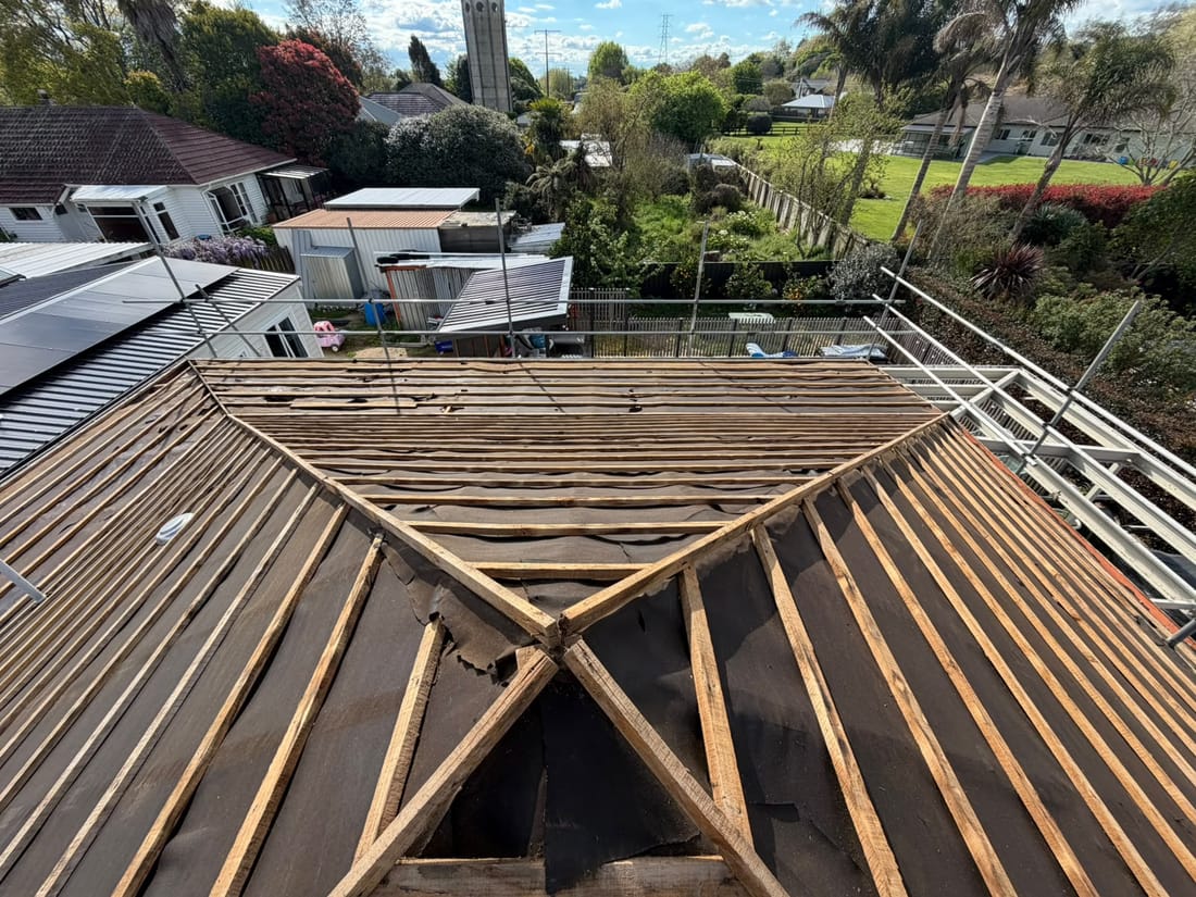 Overhead view of the same roof stripped to battens and building paper after asbestos Decramastic tile removal, Karapiro, Waikato